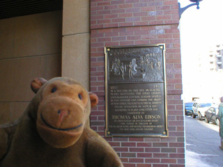 Mr Monkey with a plaque commerating Edison