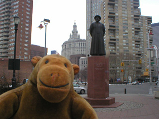 Mr Monkey in front of a Chinese statue
