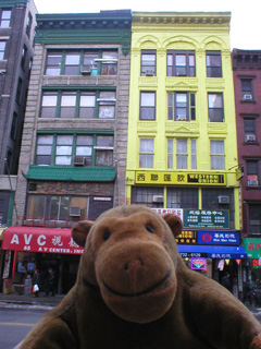 Mr Monkey looking at buildings on East Broadway