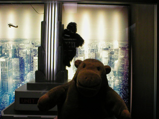 Mr Monkey with a model of King Kong climbing the Empire State Builiding