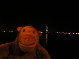Mr Monkey passing the Statue of Liberty in the night