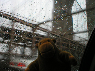 Mr Monkey in a taxi crossing the Brooklyn Bridge