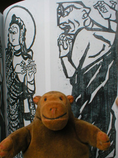 Mr Monkey in front of a picture of a drawing of two of the Ten Great Followers of Shaka