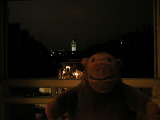 Mr Monkey looking out of his hotel window at night