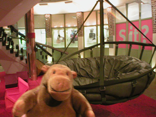 Mr Monkey examining a collection of experimental chairs