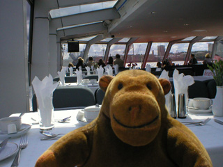 Mr Monkey looking through the front of his boat as he arrives at Greenwich