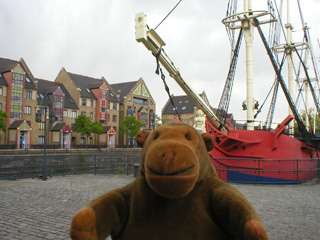 Mr Monkey looking at a replica sailing ship