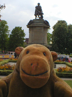 Mr Monkey looking at a statue of Shakespeare