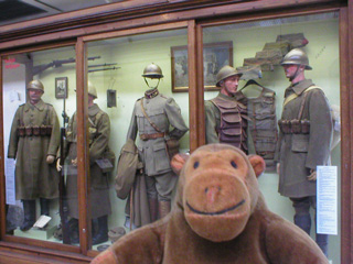 Mr Monkey with a cabinet of Belgian uniforms