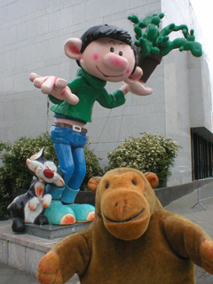 Mr Monkey with a statue of Gaston Lagaffe and his cat