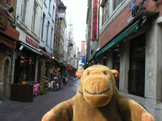 Mr Monkey in a narrow Belgian street