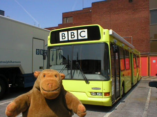 Mr Monkey in front of GMR's bright yellow bus