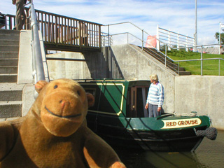 Mr Monkey watching a narrowboat leave a lock