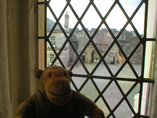 Mr Monkey looking out of a window of the Great Hall