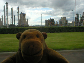 Mr Monkey driving past a chemical plant