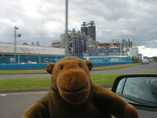 Mr Monkey driving past a chemical plant