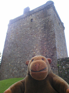 Mr Monkey looking up at Castle Campbell's tower house 