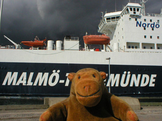 Mr Monkey overshadowed by a departing ship