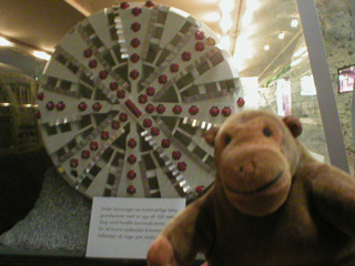 Mr Monkey with a model of a tunnel boring machine