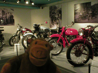 Mr Monkey with a row of motorcycles
