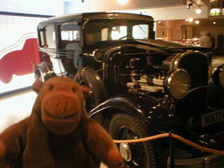 Mr Monkey looking at a 1936 Chrysler sedan