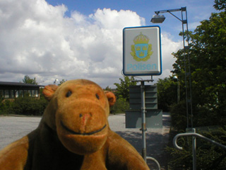 Mr Monkey beside the Ystad police station sign