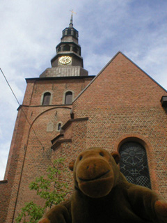 Mr Monkey looking up at the tower of the Mariakyrka