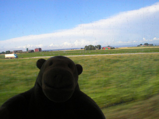 Mr Monkey watching Sweden's west coast from the train