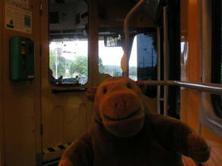 Mr Monkey looking through the front window of a tram