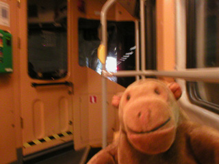 Mr Monkey looking out of a tram in a tunnel