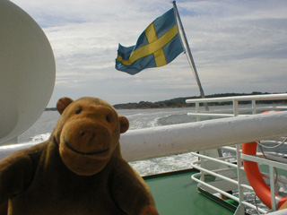 Mr Monkey watching the Swedish flag fly from the ferry