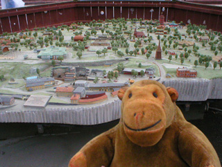 Mr Monkey looking at a large model of the Skansen