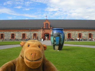 Mr Monkey looking at a giant vase in front of the Steninge cultural centre