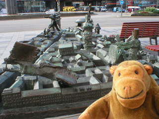 Mr Monkey looking at a sculptured street map
