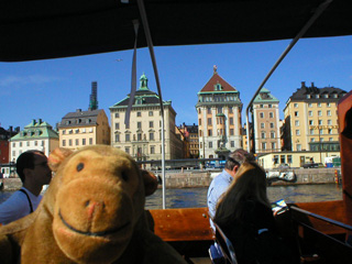 Mr Monkey boating past Skeppsbron