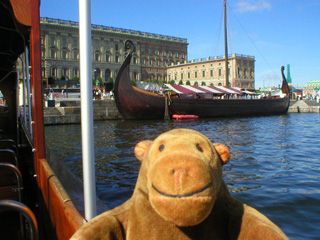 Mr Monkey looking a recreated Viking ship in front of the Kungliga Slottet