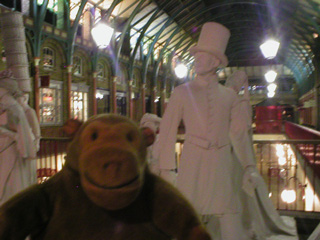 Mr Monkey examining mannequins in Covent Garden