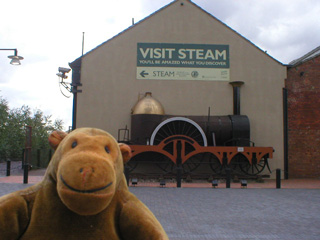 Mr Monkey following a sign directing him to visit Steam