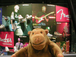 Mr Monkey in front of display about Fender footwear