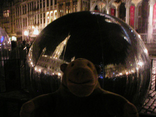 Mr Monkey in front of a reflective sphere at night