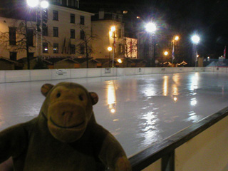 Mr Monkey beside an empty ice rink