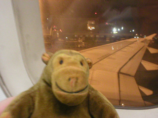 Mr Monkey looking out of the plane window at Brussels airport