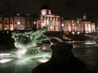 Mr Monkey examining the mermen in a fountain