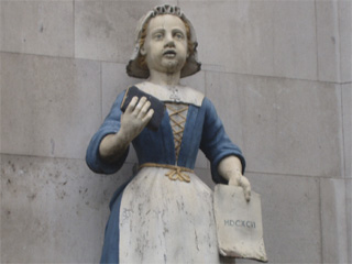 An effigy of a charity school girl outside St Andrew's Holborn