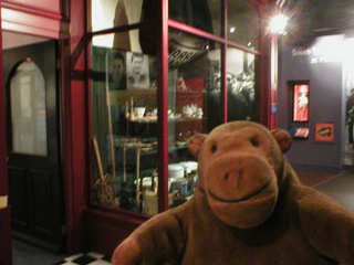Mr Monkey in front of a shop front in South Shields museum