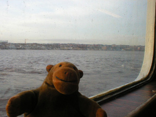 Mr Monkey looking out of the Shields ferry in mid-river