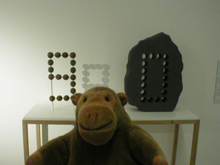Mr Monkey in front of a maquette for a sculpture