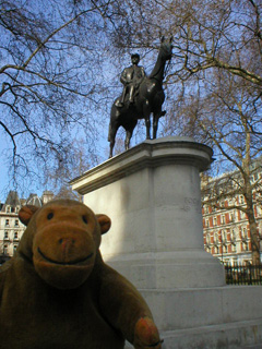Mr Monkey beneath a statue of General Foch