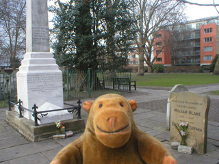 Mr Monkey looking at the graves of Blake and Defoe