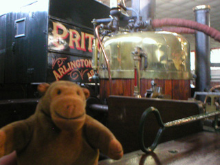 Mr Monkey inspecting the boiler of the steam carriage